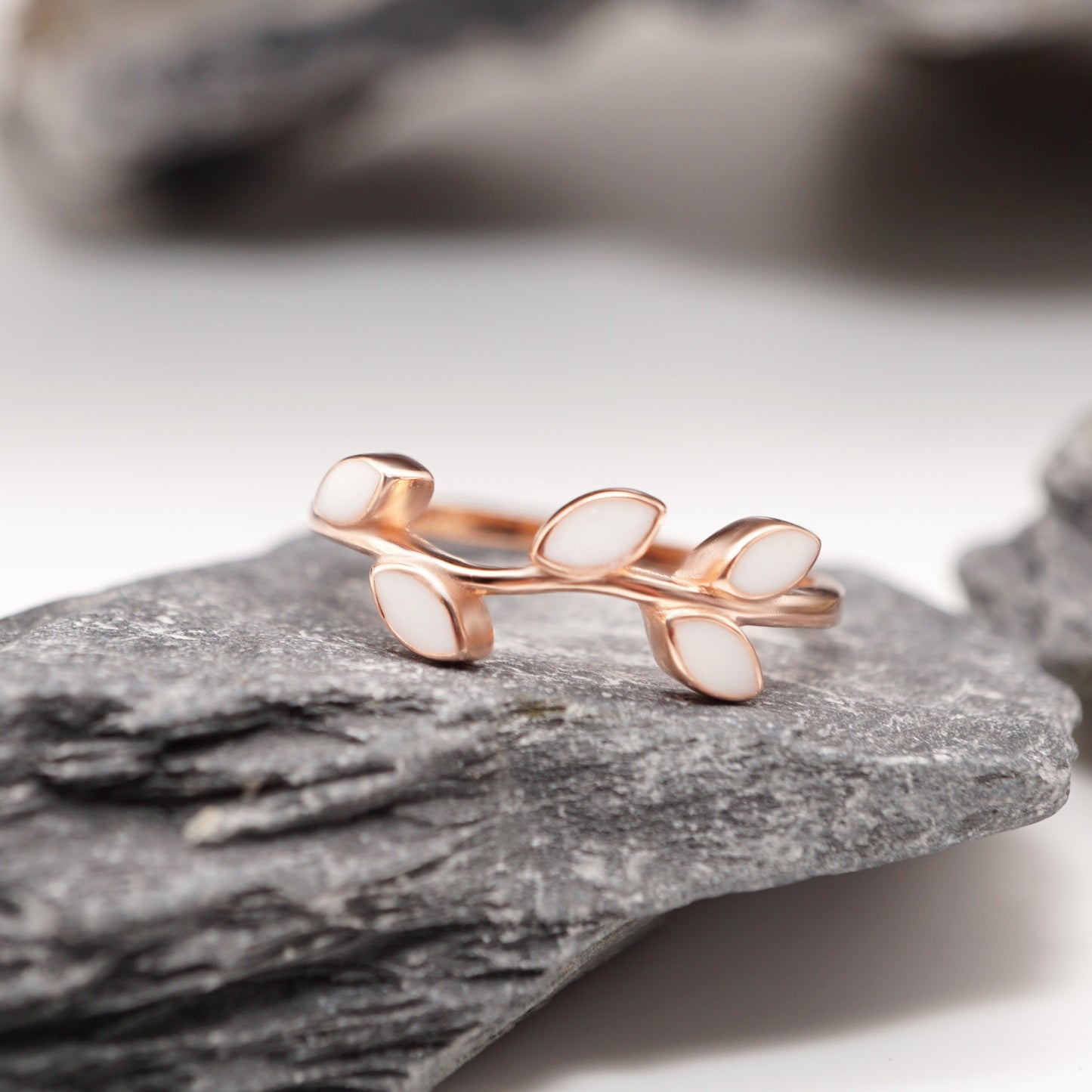 Leaf Keepsake Ring in sterling silver with custom semen inlays, displayed against a natural stone backdrop for a timeless, elegant look.