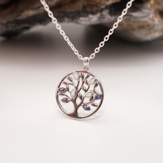 Close-up of Tree of Life Keepsake Pendant showcasing its sterling silver design with semen inlays and vibrant CZ stones.