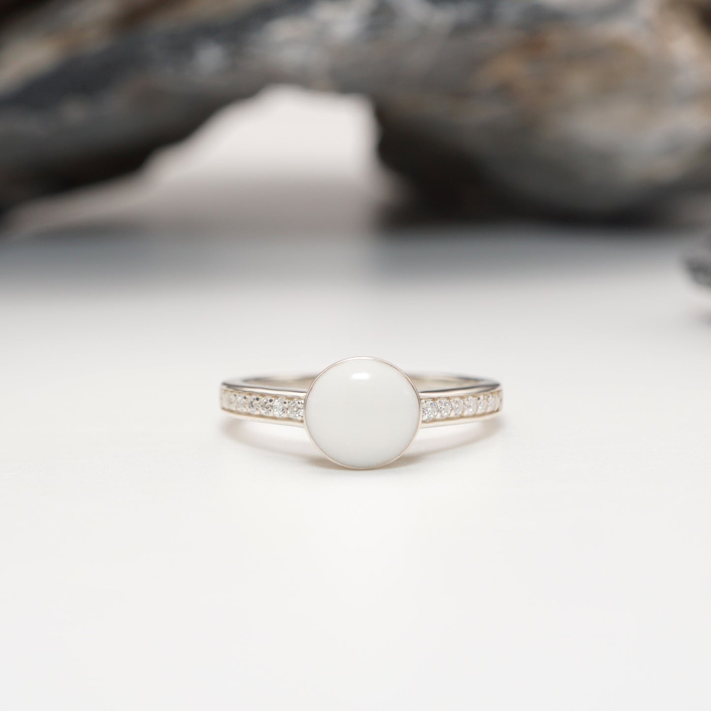 Close-up of Crown Keepsake Ring featuring polished sterling silver band, sparkling pavé stones, and bold semen inlay centrepiece.