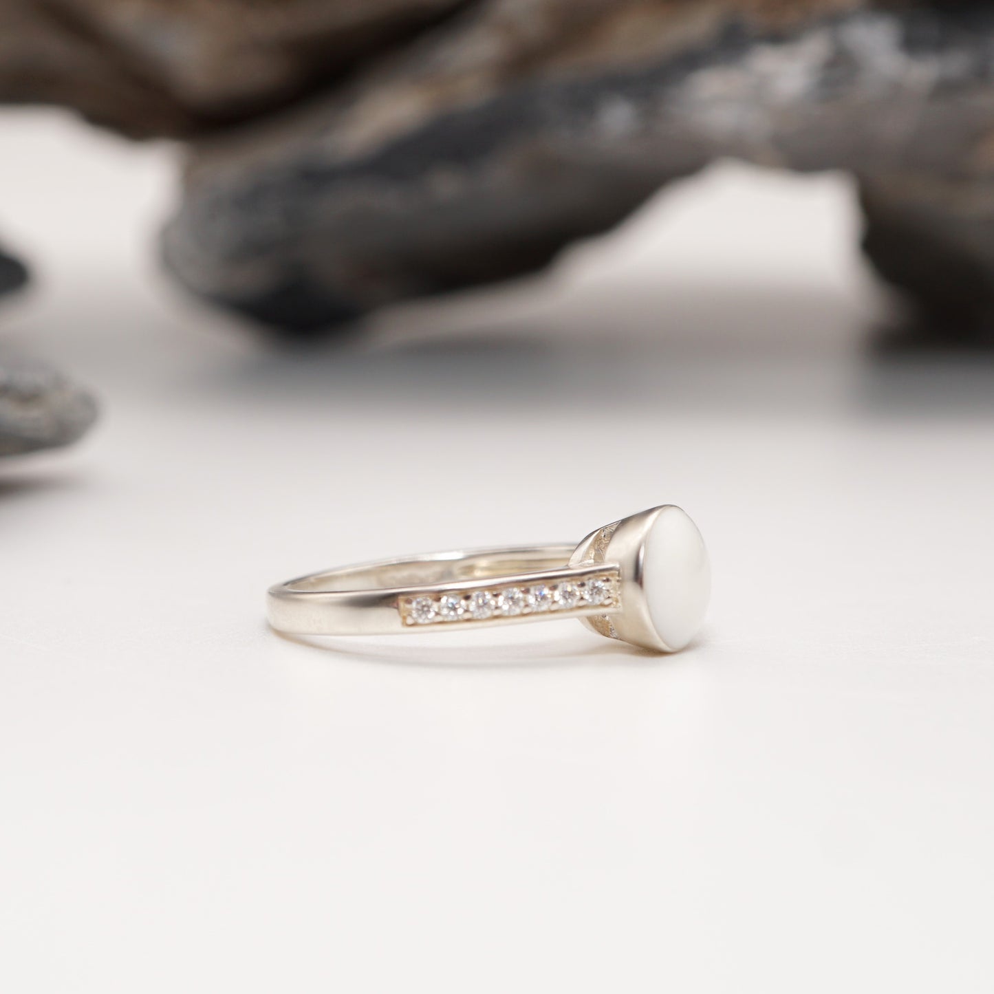 Side view of Crown Keepsake Ring with sterling silver band, pavé detailing, and sleek round semen inlay.