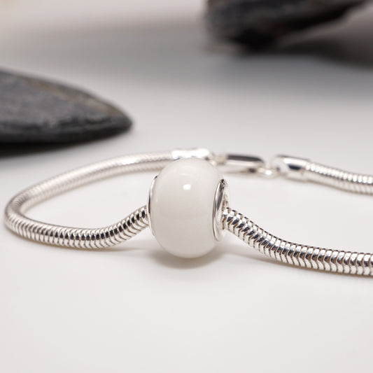 Lust Bead attached to a sterling silver charm bracelet—an intimate and daring keepsake in a sleek design.
