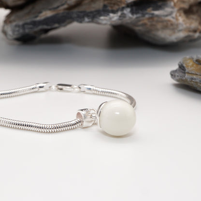 Close-up of the Orb Keepsake Pendant, showcasing its smooth resin sphere inlay and sleek sterling silver detailing.