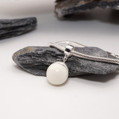Orb Keepsake Pendant with a bold resin sphere inlay and sterling silver cap, displayed on a minimalist background.