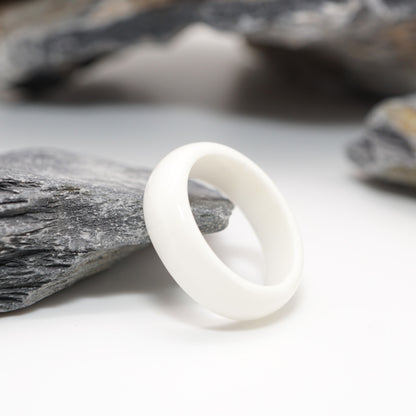 Pure Resin Keepsake Ring displayed on a natural stone backdrop, highlighting its smooth resin inlay and organic design.