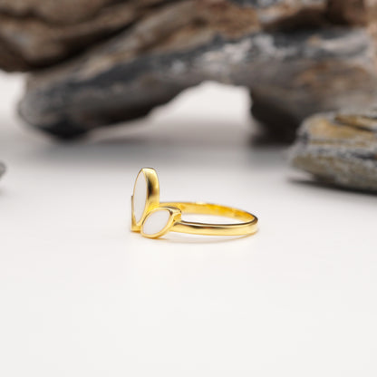 Zoomed-in shot of Petal Keepsake Ring in sterling silver with custom semen inlays, featuring intricate petal shapes and polished finish.