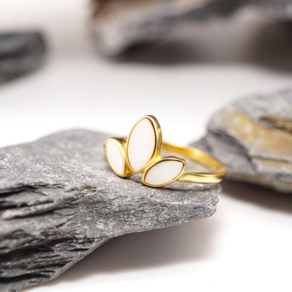 Close-up of Petal Keepsake Ring showcasing its sleek gold-plated band and delicate three-petal design with personal semen inlays.