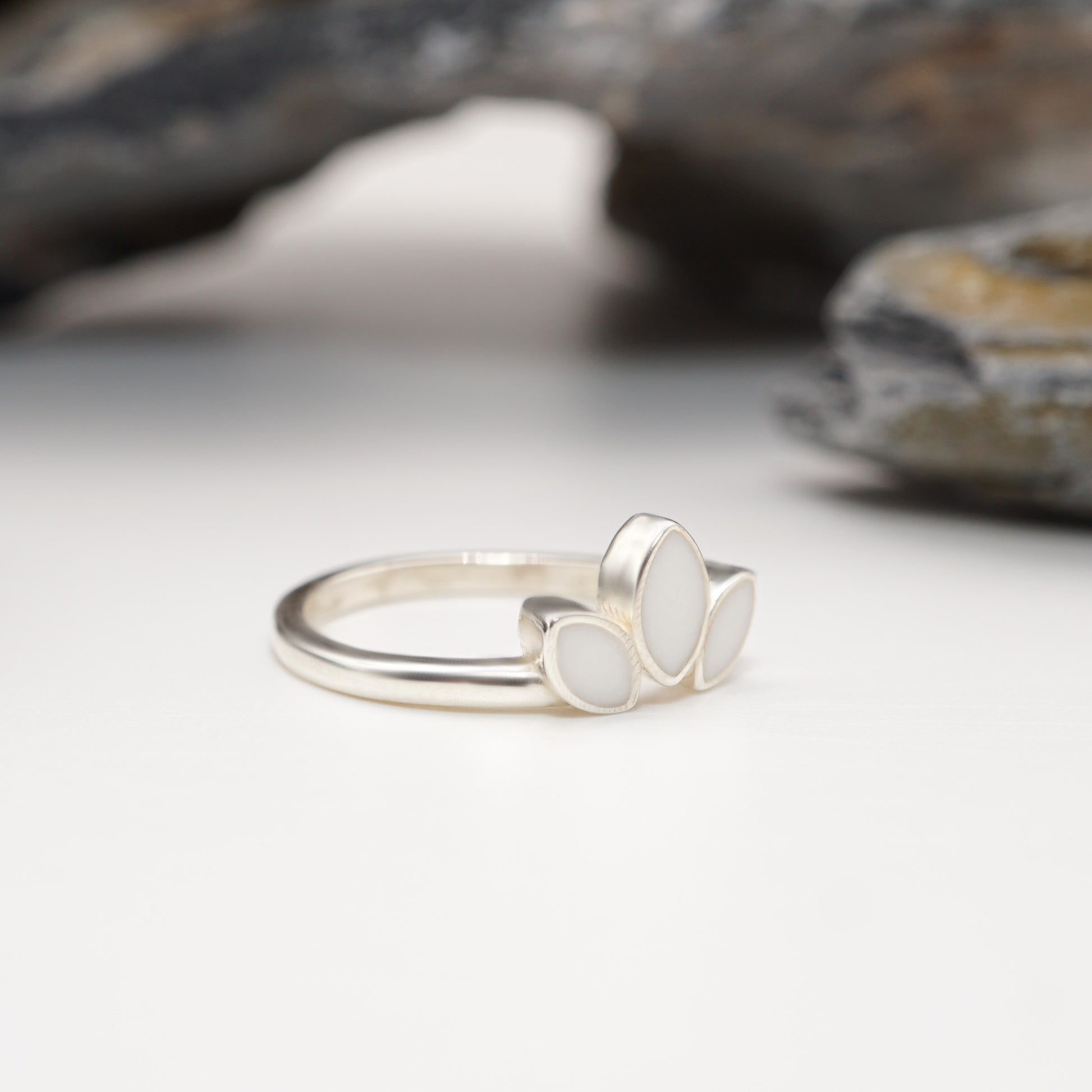 Side view of Petal Keepsake Ring in sterling silver, highlighting its smooth finish and intricate petal-inspired design with custom inlays.