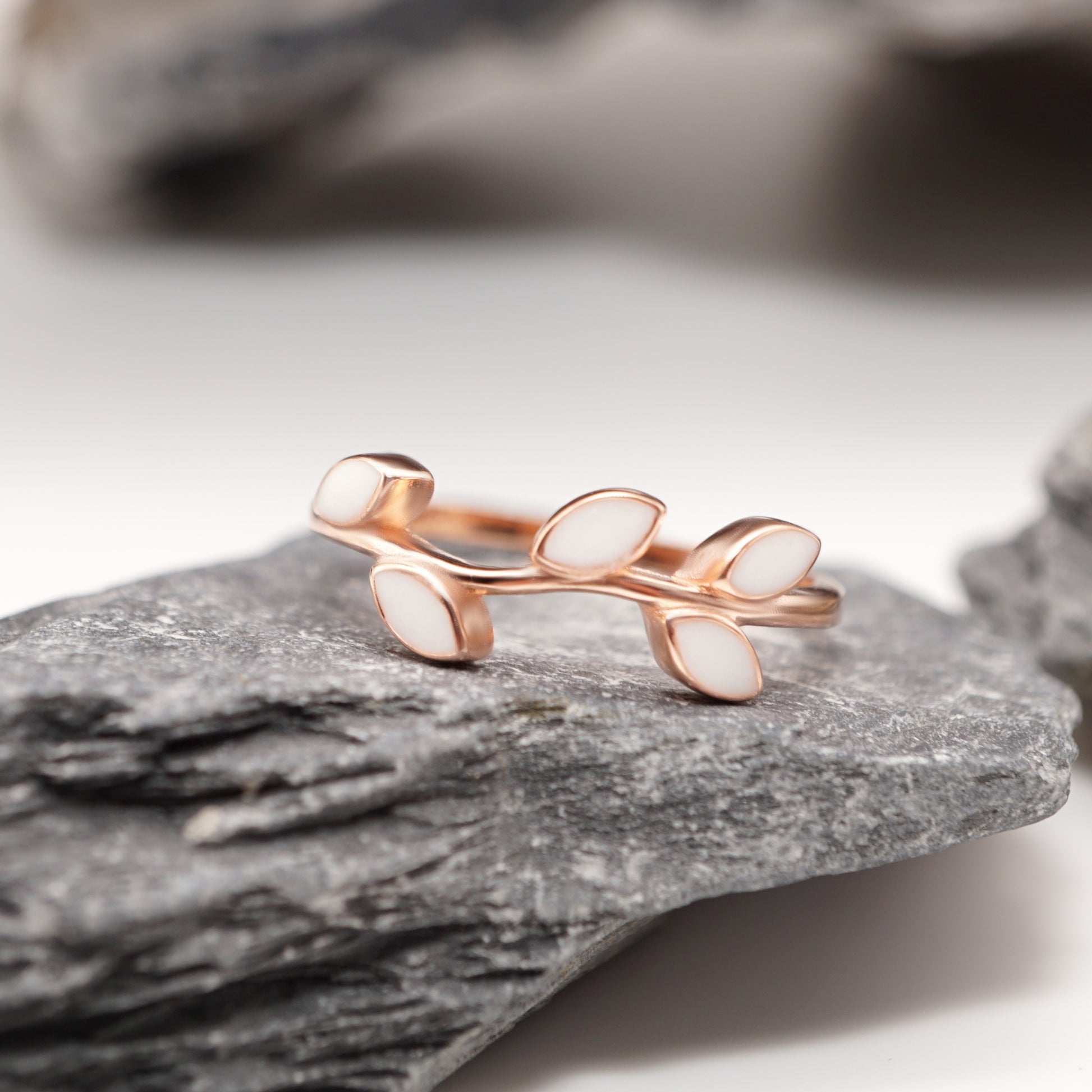 Leaf Keepsake Ring in sterling silver with custom semen inlays, displayed against a natural stone backdrop for a timeless, elegant look.