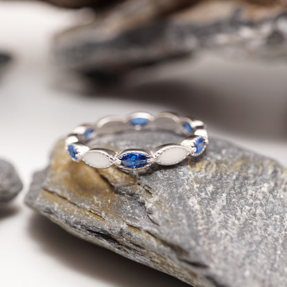 Close-up of Eternity Keepsake Ring showcasing its sleek sterling silver band, bold blue CZ stones, and custom semen inlays.