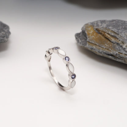 Side view of Luxe Keepsake Half Band with polished sterling silver band, alternating semen inlays, and blue CZ stones.