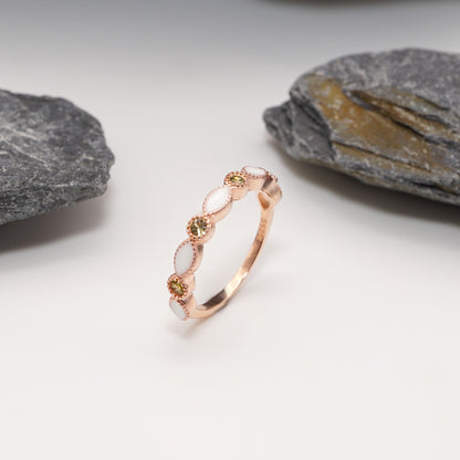 Luxe Keepsake Half Band ring in sterling silver rose gold plated, with custom semen inlays and CZ stones in blue, elegantly displayed against a natural stone backdrop.