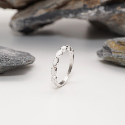 Close-up of Silhouette Keepsake Ring showcasing its smooth sterling silver band and personal marquise semen inlays.