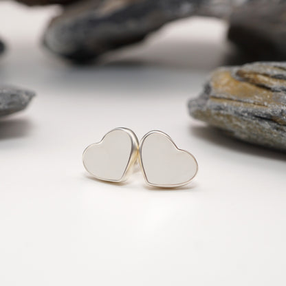 Heart-shaped sterling silver earrings with custom semen inlays, bold and intimate jewellery for a unique and personal style