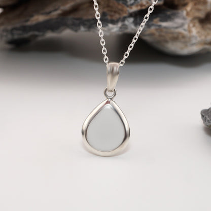 Close-up of Teardrop Keepsake Pendant in sterling silver, showcasing sleek design and unique semen inlay.