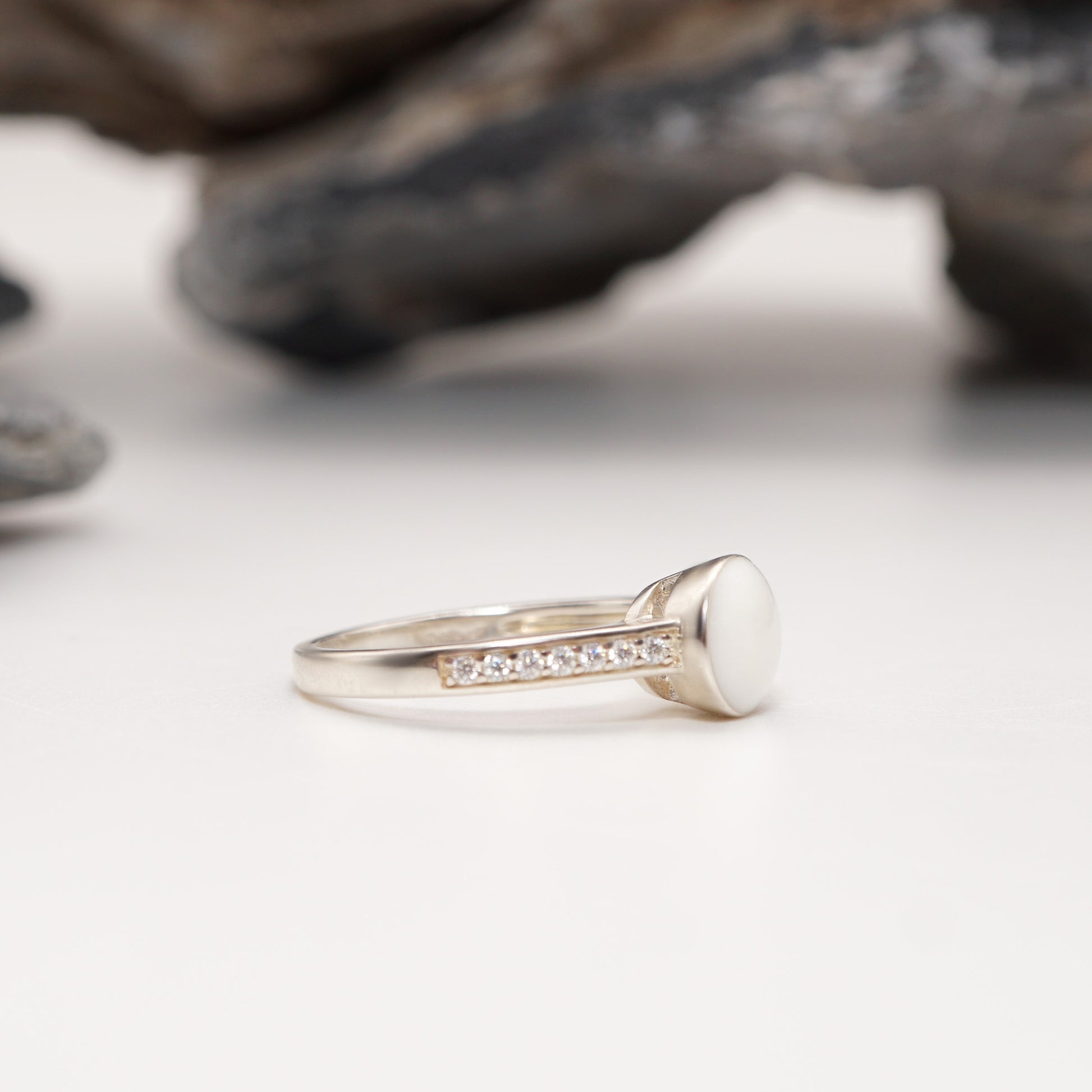 Side view of Crown Keepsake Ring with sterling silver band, pavé detailing, and sleek round semen inlay.
