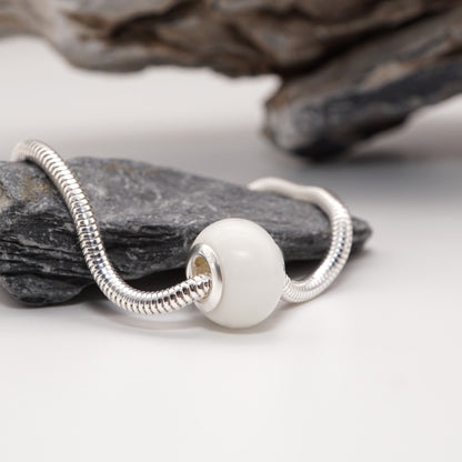 Lust Bead with a polished, seductive resin core and luxury metal detailing, displayed on a neutral backdrop.